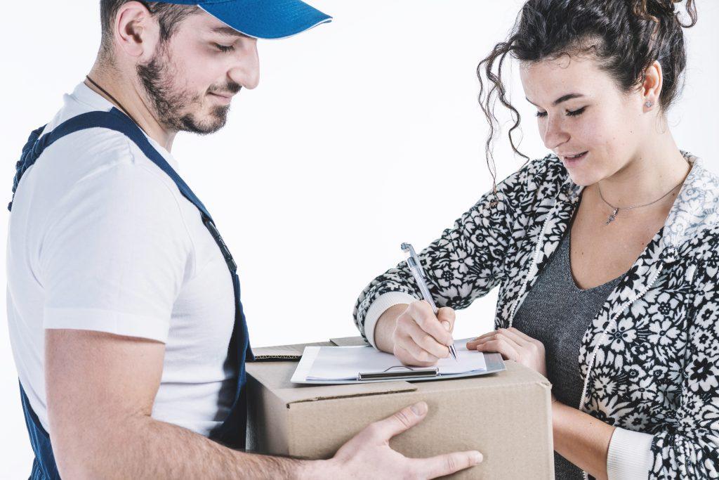 beautiful woman signing parcel Order Taking & Processing