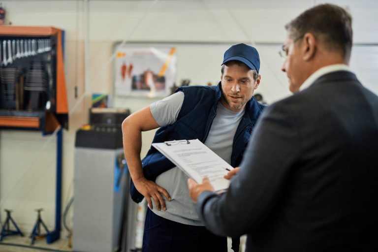auto repairman businessman analyzing reports while working car workshop Air Conditioner Installation
