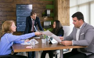 middle age business woman giving charts her young colleague conference room 1 T Testimonials
