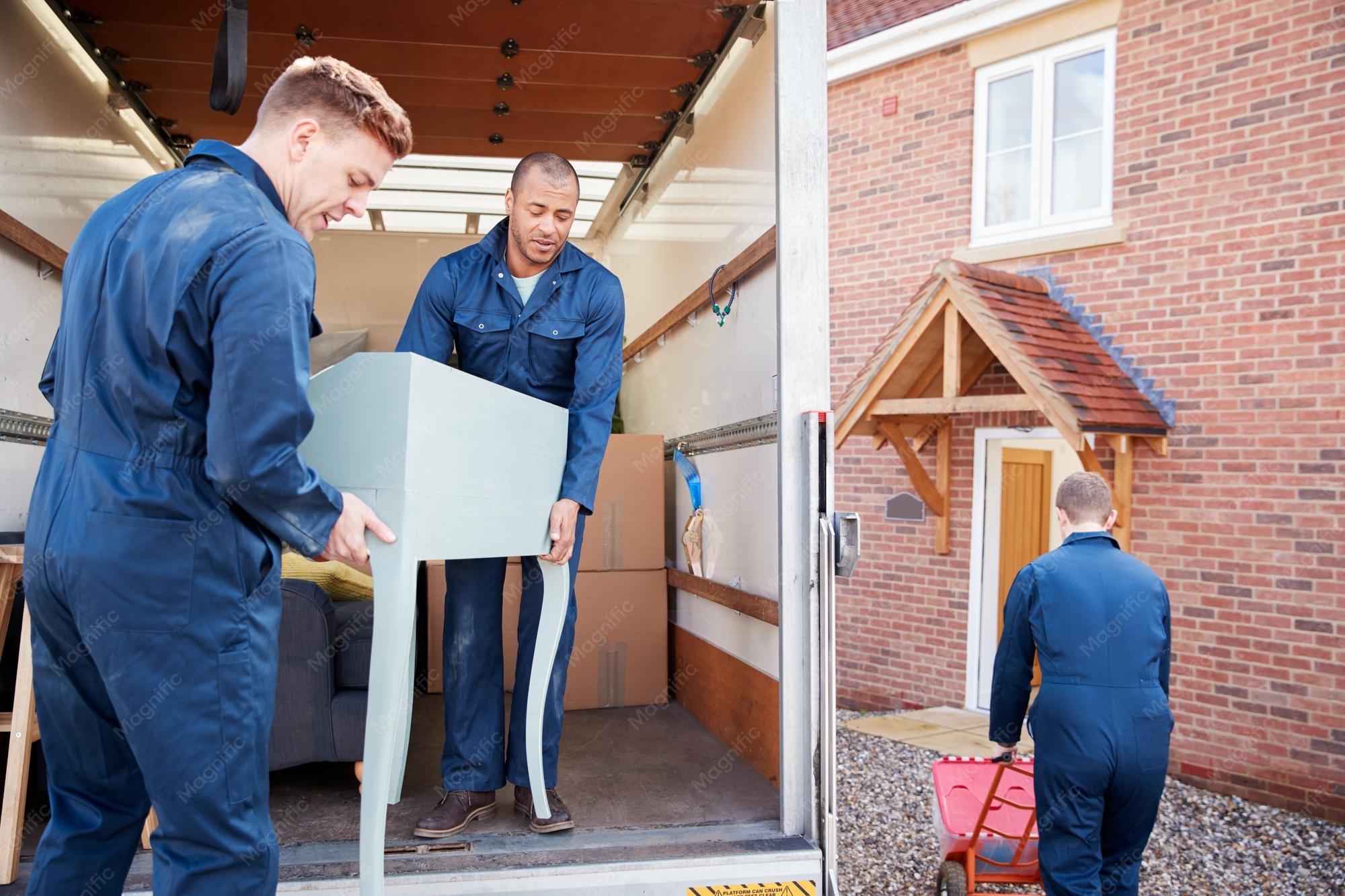 removal company workers unloading furniture boxes from truck into new home moving day 1218270 6538 Home Renovation