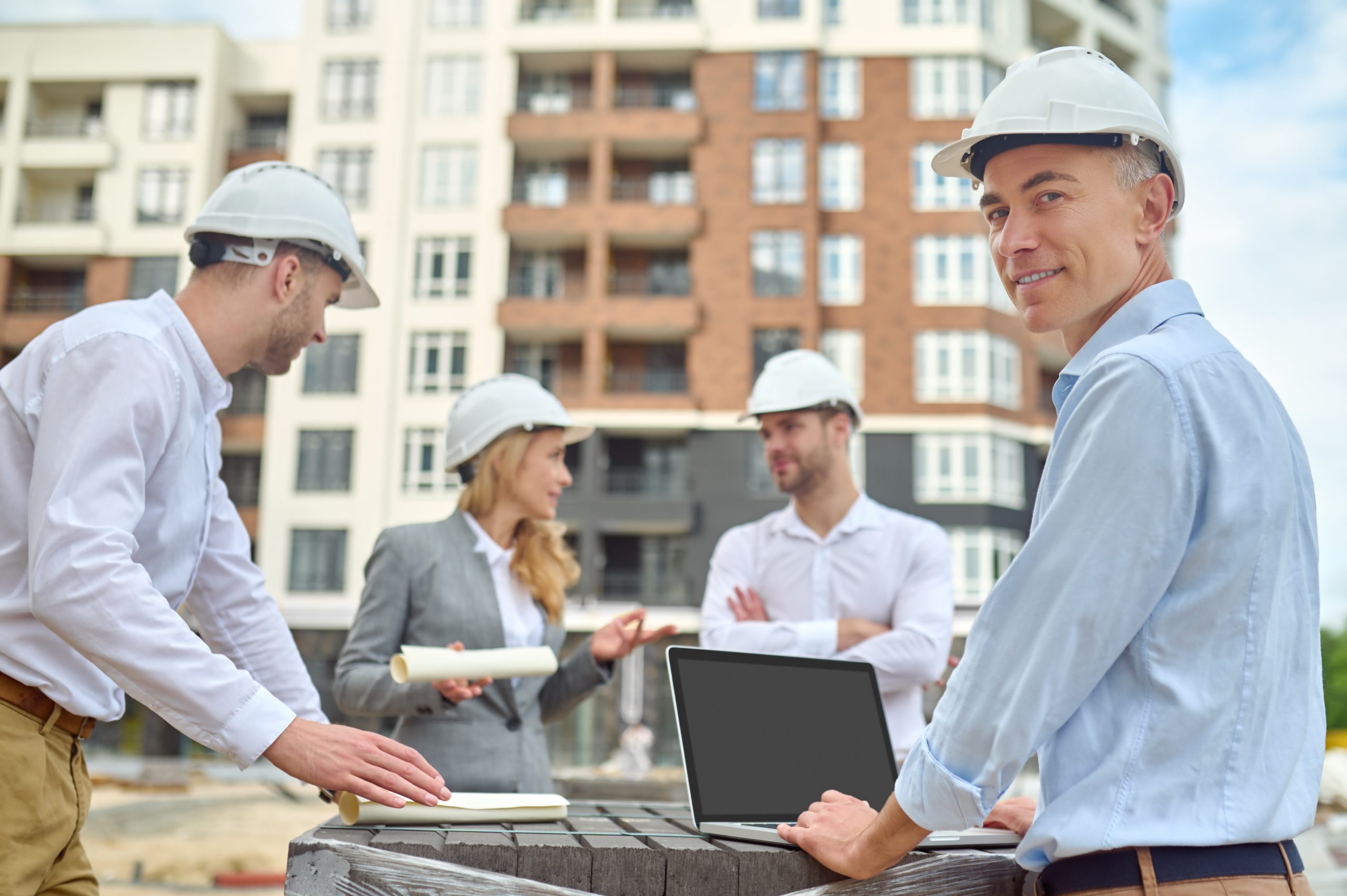 worker standing his three coworkers construction site scaled Modular and Prefabricated Build