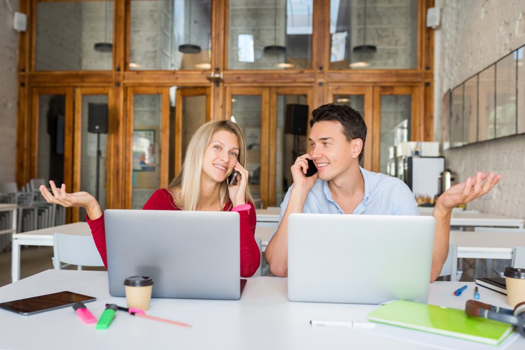 young man woman working laptop open space co working office room Cold Calling vs Email Outreach: 7 Proven Insights for Booking More Meetings