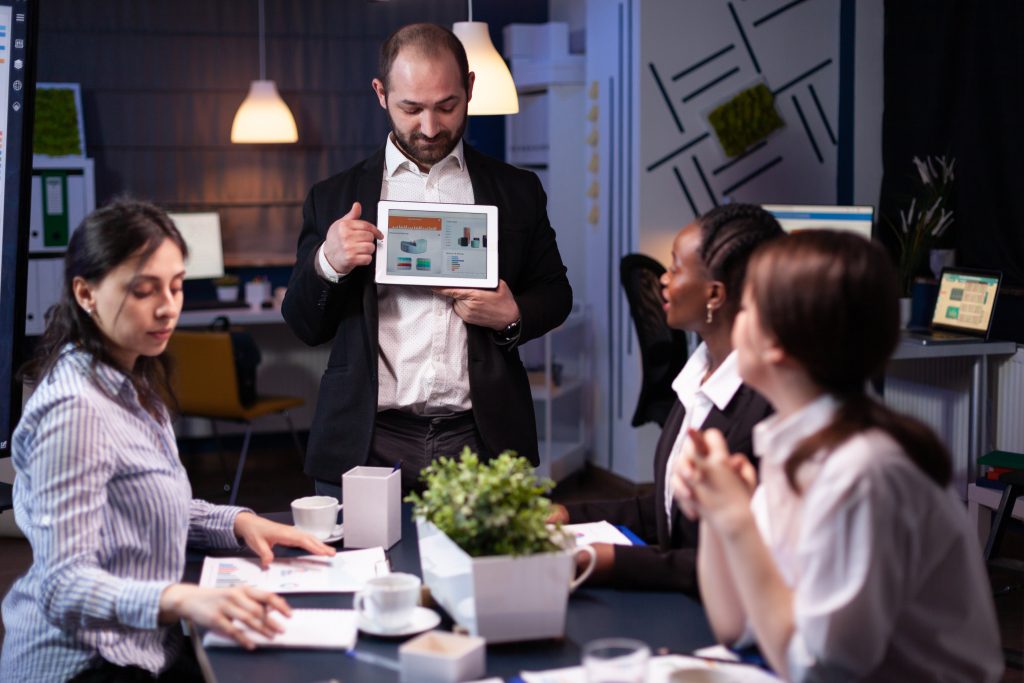 focused businessman showing corporate graphs presentation using tablet working company ideas Calculating Your Lead Generation ROI: 7 Smart Steps to Know What Works