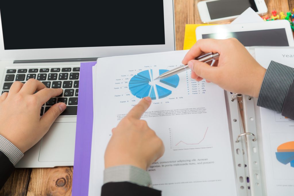 men suit analyzing results chart SDR Performance Metrics: How Many Appointments Monthly?