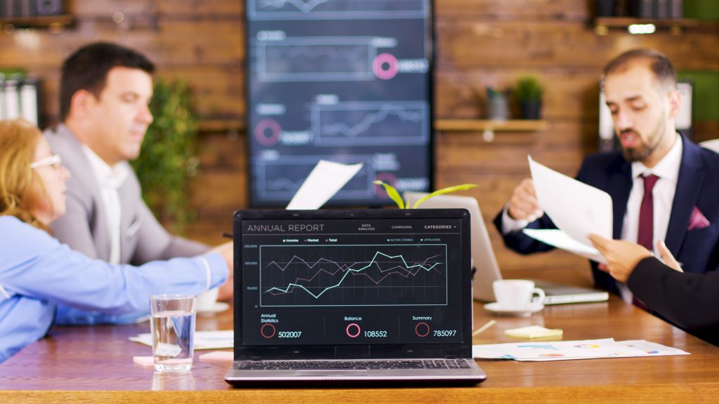 table laptop showing charts conference room business people having important discussion SDR Performance Metrics: How Many Appointments Monthly?
