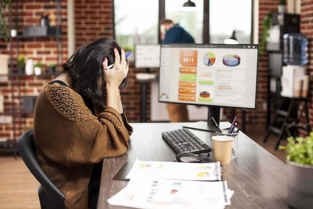 woman resting her head office desk Calculating Your Lead Generation ROI: 7 Smart Steps to Know What Works
