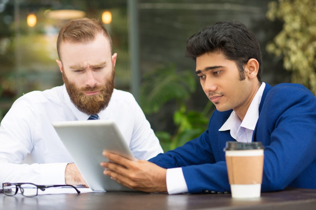 concentrated multi ethnic business partners using tablet How VoltEdge Reached OEM Buyers Through Technical Qualification