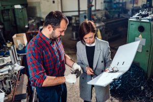 machinist standing with female engineer measuring cogwheel diameter 137573 2819 Case Studies