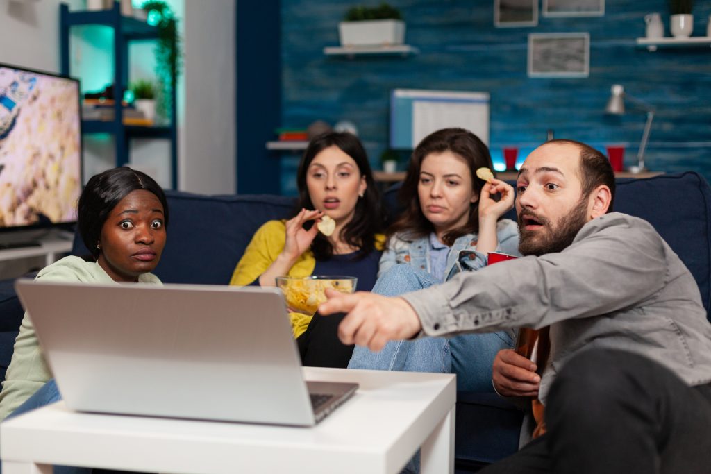 multi ethnic friends spending time together looking entertainment laptop talking about lifestyle group multiracial people relaxing having fun chilling movie night hanging out How EventPulse Entertainment Won Better Buyers With Appointment Setter Online