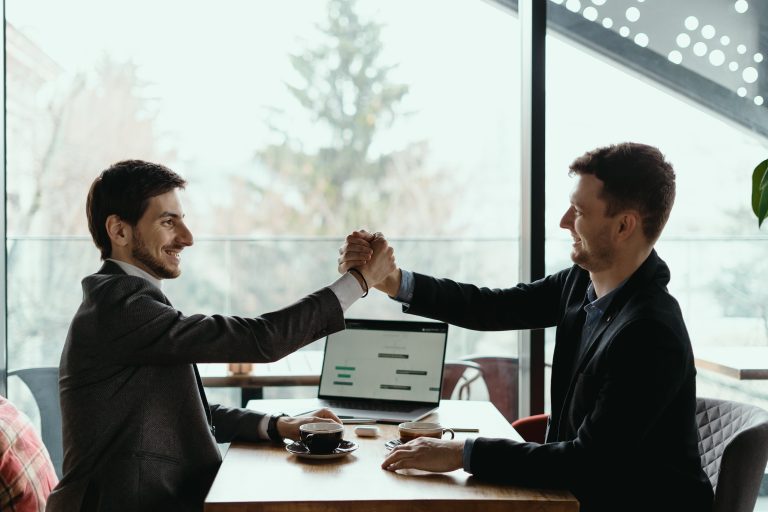 two business men celebrating deal Lead Qualification Framework: 5 Steps to Better Sales