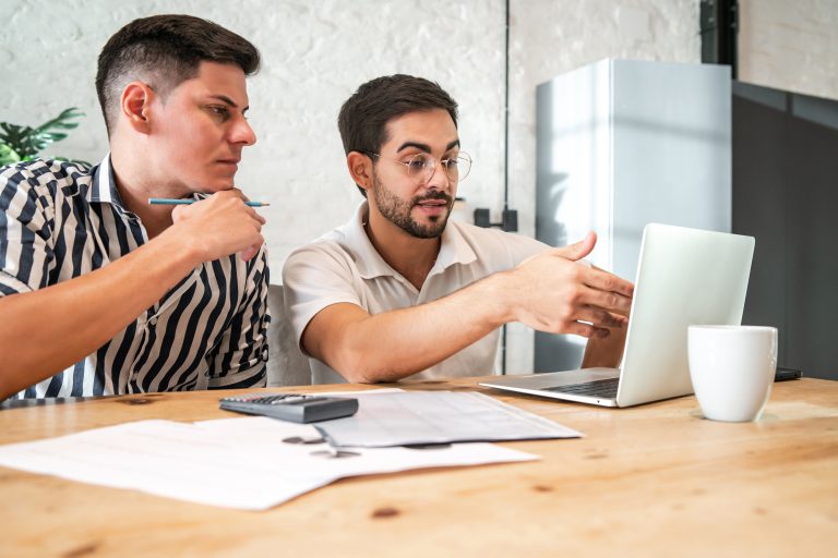 young gay couple planning their home budget paying their bills online with laptop while staying home finance concept 1 7 Best CRM for Appointment Setting in 2026